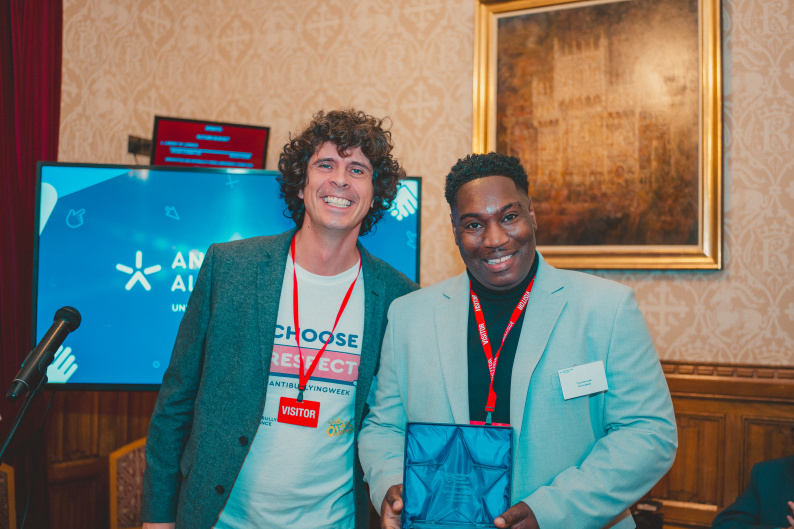Tyron (right) receiving School Staff Award from Andy Day 